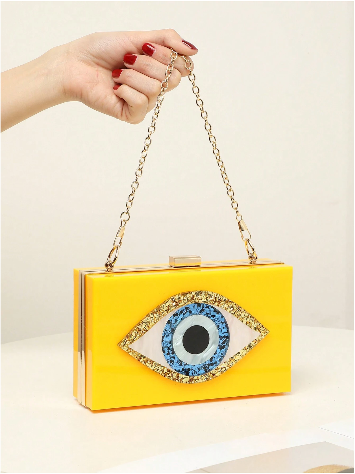 Bolso clutch ojo protector